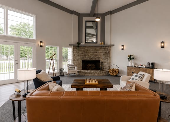 A living room with a fireplace and a brown couch.