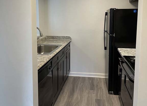 Spacious kitchen with wood style plank flooring at Camelot East Apartments, Ohio, 45014