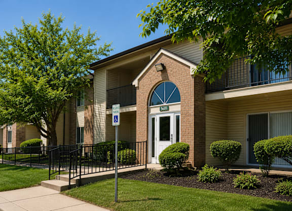 A building with a white door and a blue sign on the left.