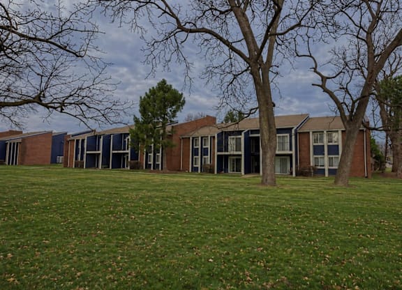 A row of houses with trees in front.