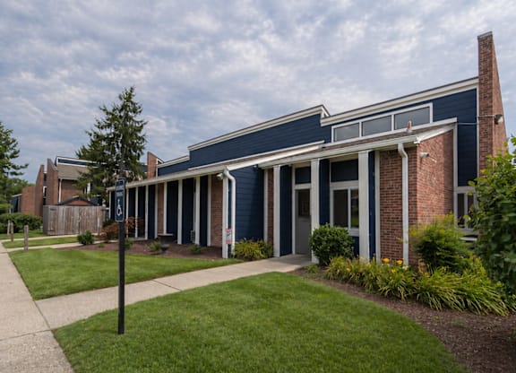 A blue and brick building with a white trim.