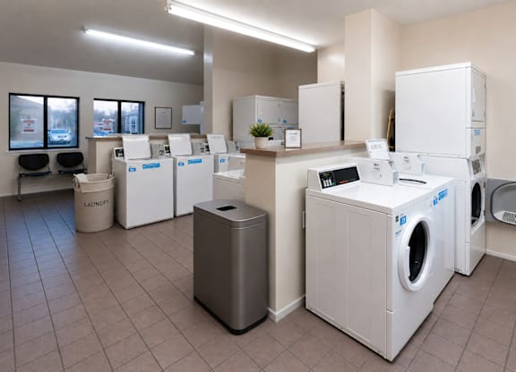 A laundry room with washers and dryers.
