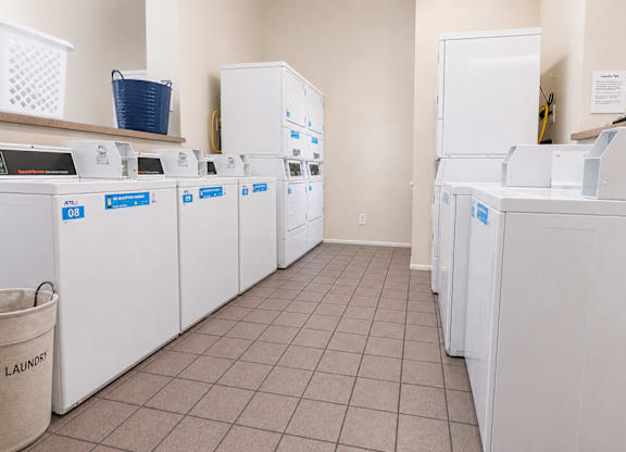 A row of washing machines in a laundromat.