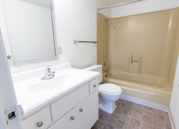 a bathroom with a sink toilet and a tub