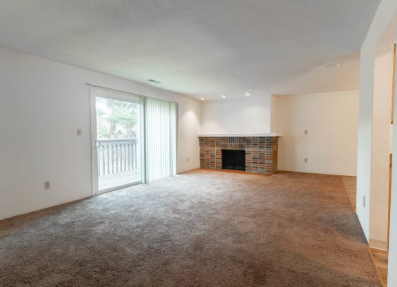 the living room of an empty house with a fireplace