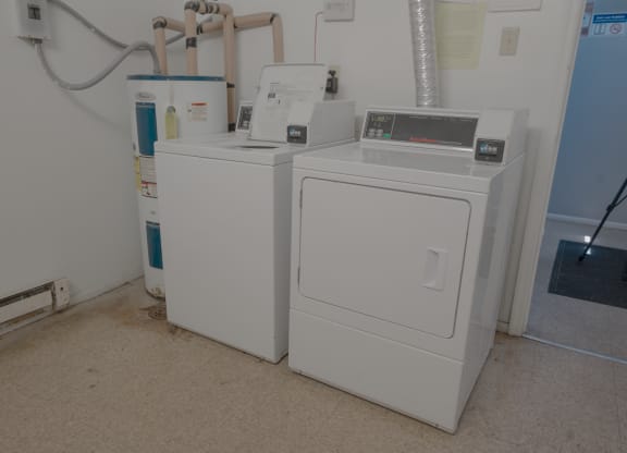 two washing machines next to each other in a room