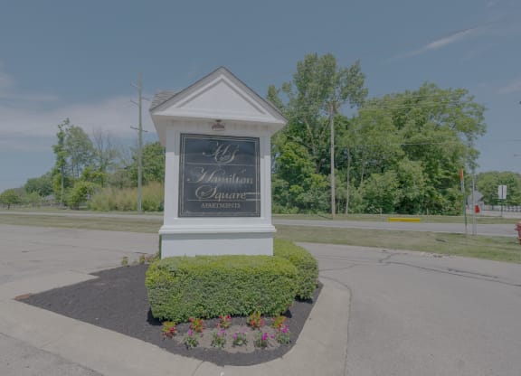 the sign at the intersection of a street with a parking lot