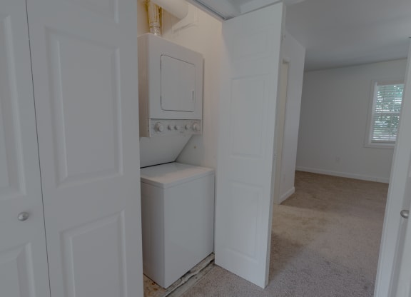 an empty laundry room with a washer and dryer