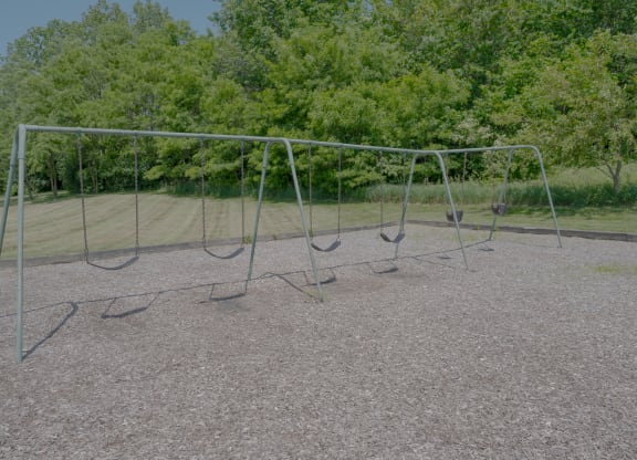 an empty swing set in a park