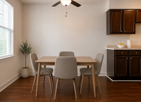 A dining room with a table and chairs.