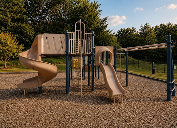 A playground with a slide, swings, and a climbing structure.
