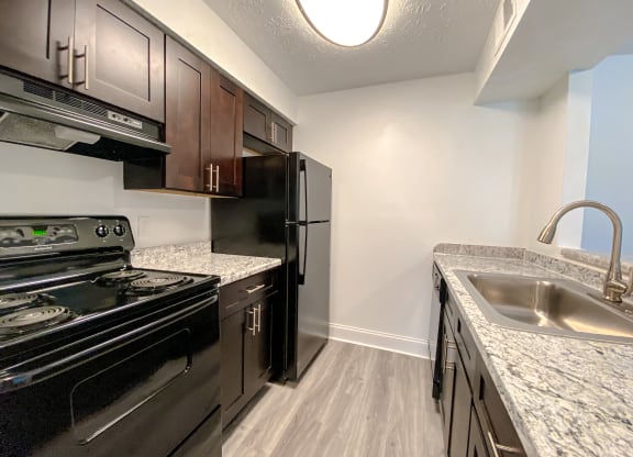 Spacious kitchen with wood style plank flooring at Camelot East Apartments, Fairfield, Ohio