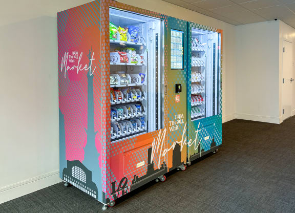 Whit Market vending machine with snacks, drinks, and convenience items at The Whit Apartments in Indianapolis, IN 46204