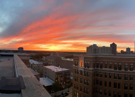 a view of the sunset from the roof of a building