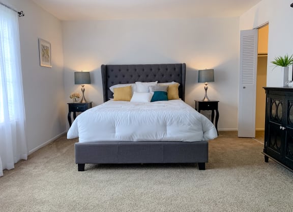 Spacious modern bedroom with walk-in closet at The Lodge Apartments in Indianapolis, IN