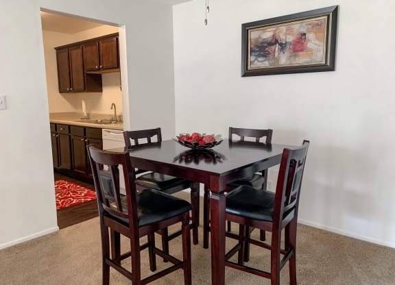 Spacious dining room open to the living room at The Lodge Apartments in Indianapolis, IN