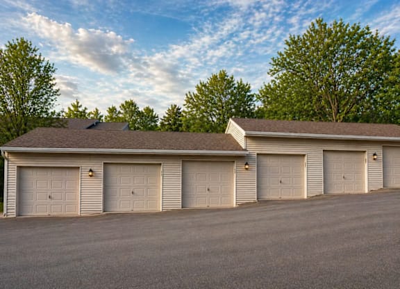 A large building with a brown roof and six garage doors.