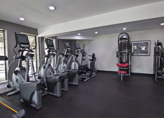 Large fitness center with modern workout equipment at Camelot East Apartments, Fairfield, OH