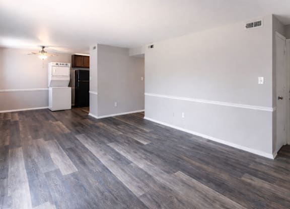 A room with a wooden floor and white walls.