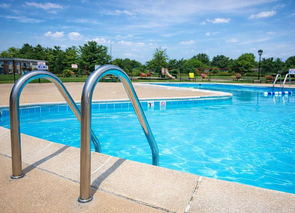 A blue pool with a ladder on the side.