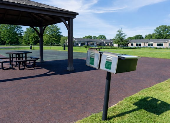 A gazebo is in the middle of a brick patio.