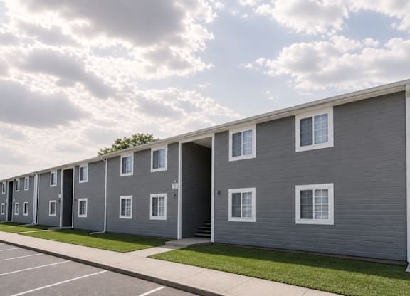 A row of grey houses with white windows and doors.