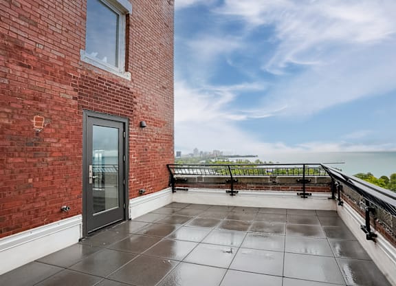 the private balcony has a view of the lake and the city at Park Heights by the Lake Apartments, Chicago, 60649