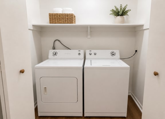 A small laundry room with a washer and dryer.