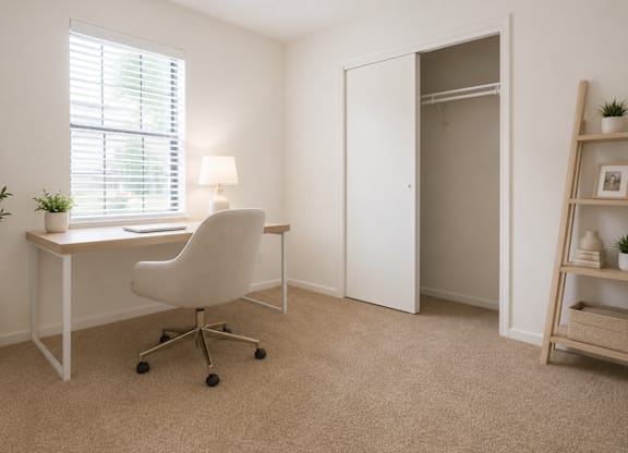 A white desk with a white chair and a white plant in a white pot.