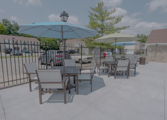 a patio with tables and chairs and umbrellas