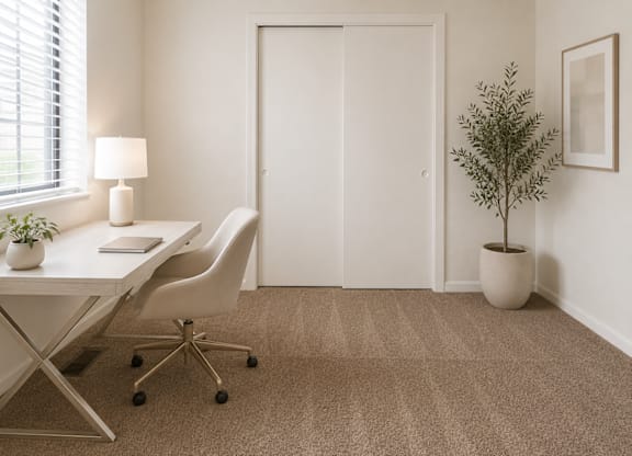 A white desk with a lamp and a plant on it.