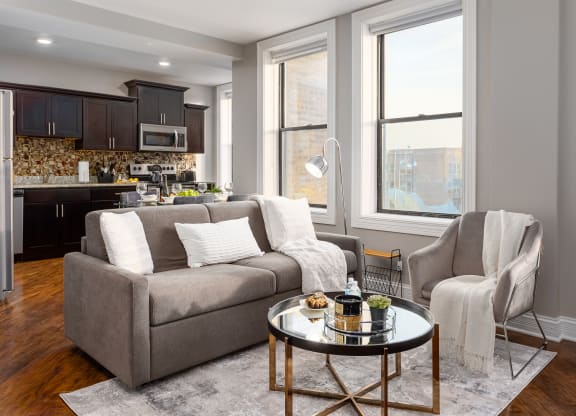 a living room with a couch and a chair and a table