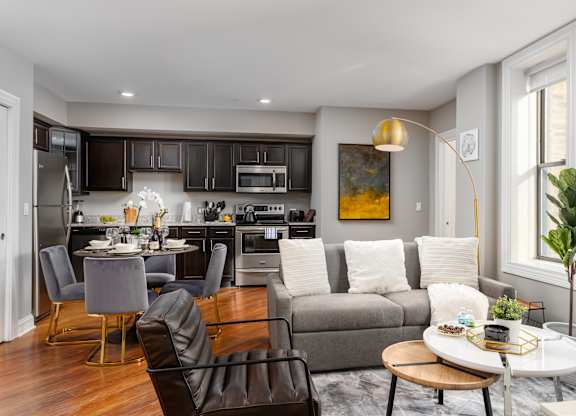 a living room and kitchen with a couch and a table