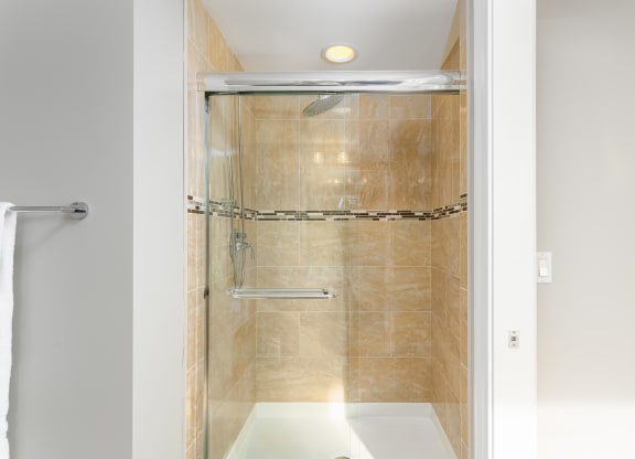 a shower with a glass door in a bathroom