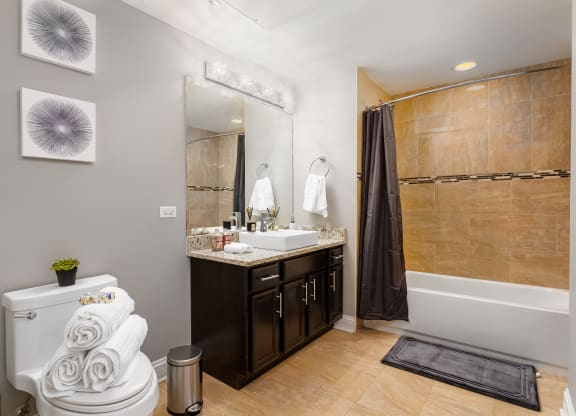 a bathroom with a toilet and a sink and a shower