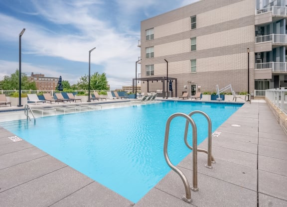 a swimming pool with a building in the background