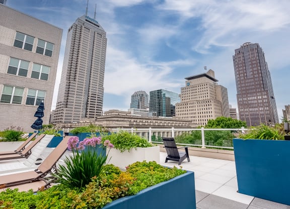 a roof terrace with a view of the city