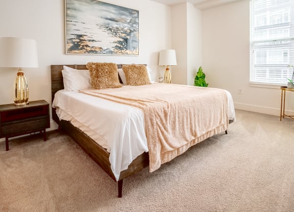 a bedroom with a bed and two windows