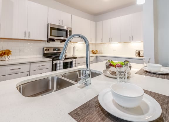 a kitchen with a sink and a counter with a bowl on it
