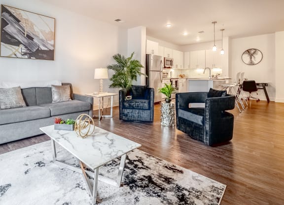 a living room with couches and chairs and a table