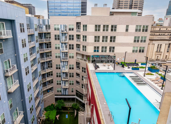 a large swimming pool in front of a tall building