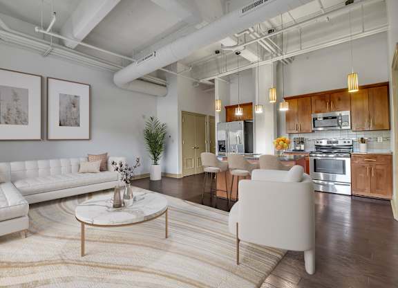 a living room with a white couch and a table at 100 South Apartments, Buffalo, NY 14202