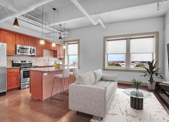A modern kitchen with a white ceiling and a large window. at 100 South Apartments, Buffalo, NY