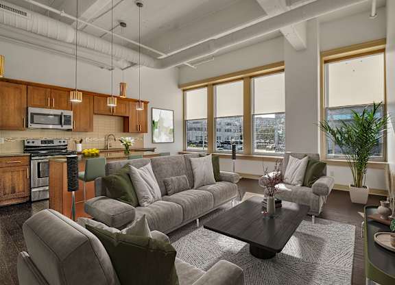 A modern living room with a grey sofa set and a wooden coffee table. at 100 South Apartments, New York, 14202
