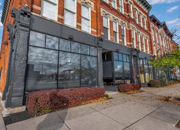 A red brick building with a black awning.