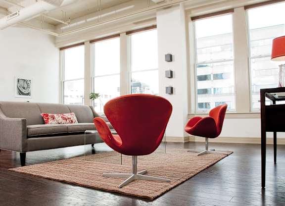 a living room with a couch and chairs and a rug at 100 South Apartments, New York, 14202