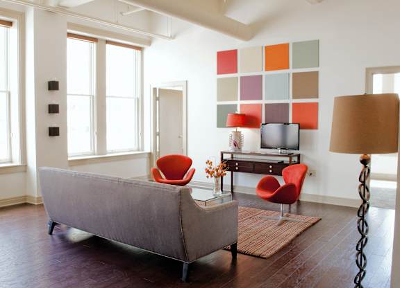 a living room with a couch and chairs and a television at 100 South Apartments, New York