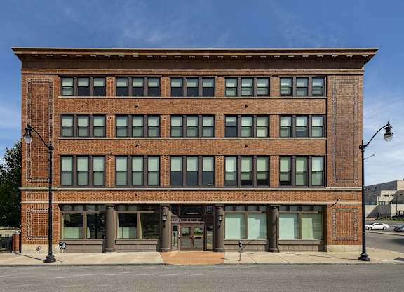 an old brick building on the corner of a street at 100 South Apartments, Buffalo, NY 14202