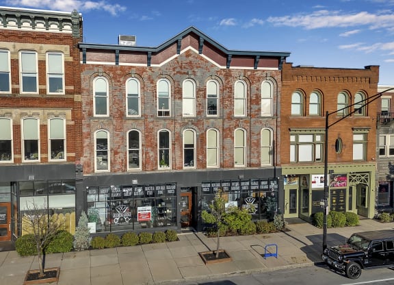 a large brick building on the corner of a city street at The Granite Works Apartments , Buffalo, New York