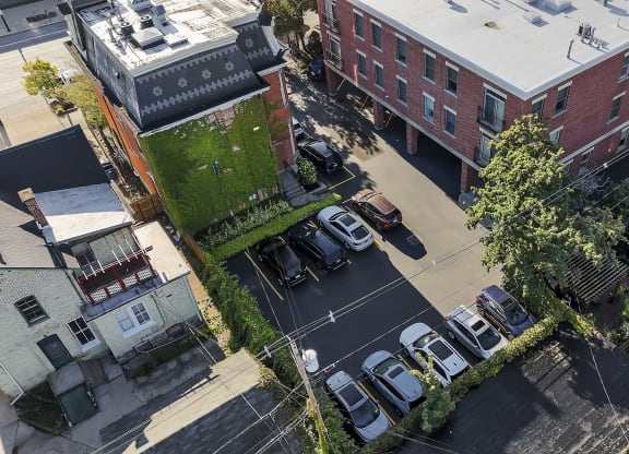 an aerial view of a city street with cars parked in a parking lot at The Granite Works Apartments , Buffalo, NY, 14202